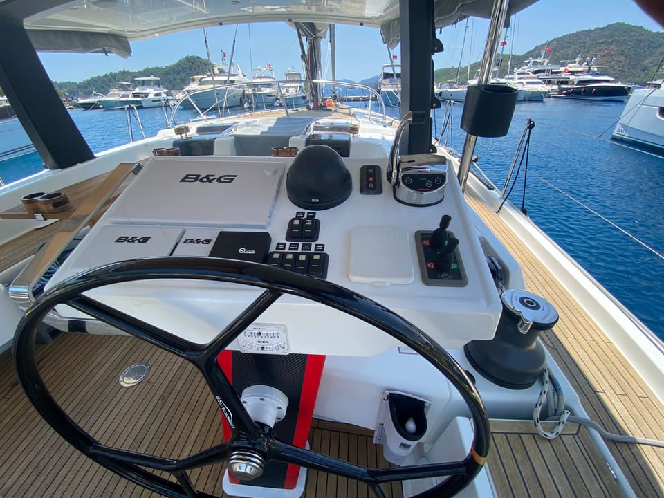 2018 Hanse 548 – helm station with wheel, B&G instruments, chartplotter and engine controls under bimini