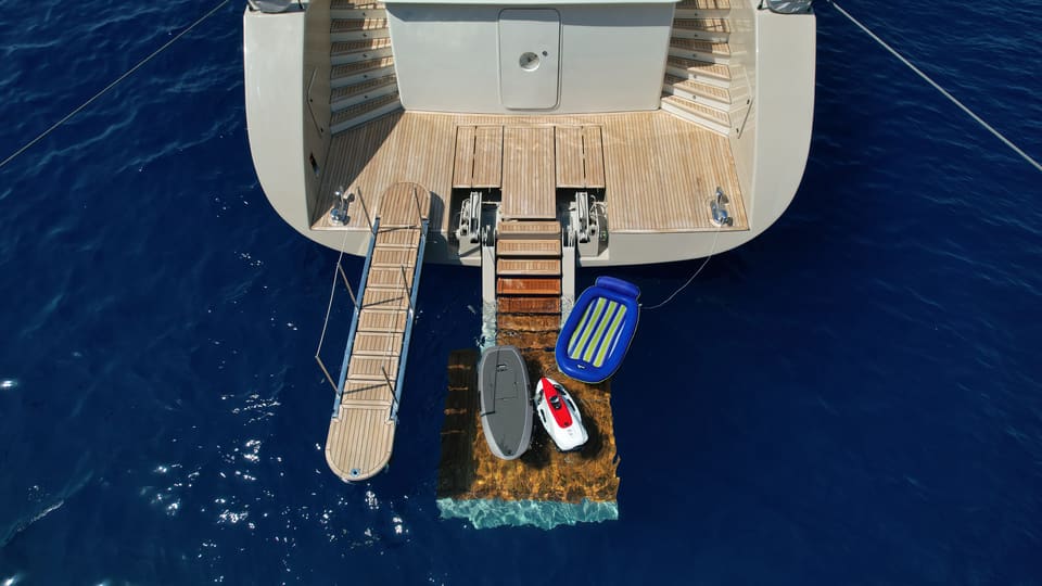 2023 Custom Laminated Motorsailer 41M – aerial view of stern with swim platform, gangway, water toys and floating sea pool