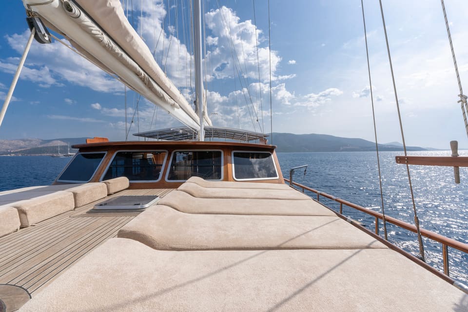 2009 Custom Ketch 31M – foredeck with large sun pads, teak deck and sea views beneath the furled mainsail