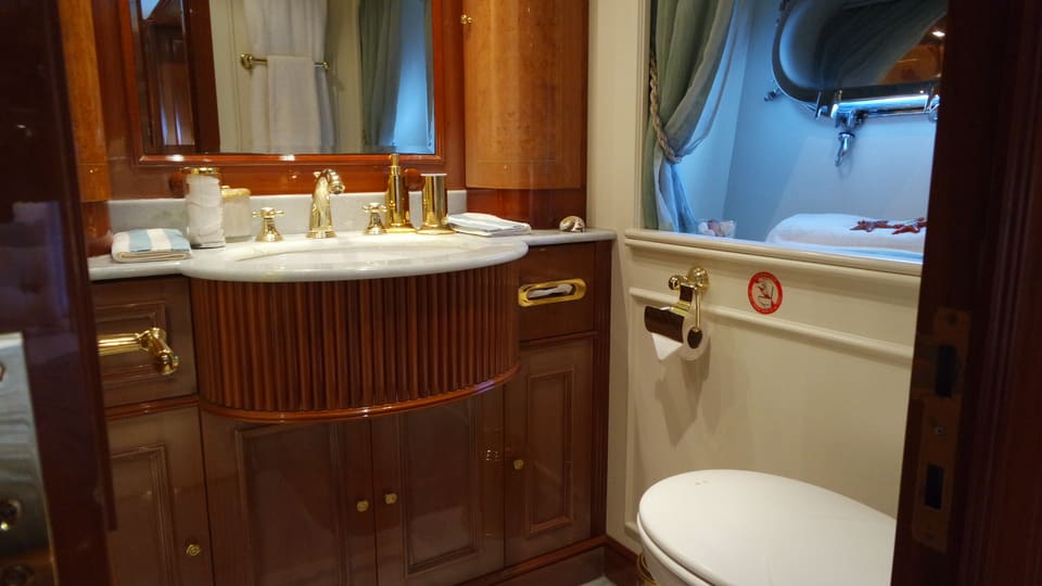2003 Benetti Classic 115 – bathroom with marble vanity, gold fixtures and fluted wood cabinetry
