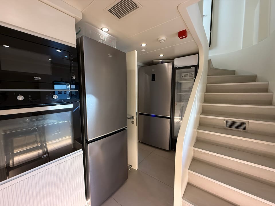 2023 Custom Laminated Motorsailer 41M – galley with built-in ovens, stainless fridges, drinks cooler and staircase