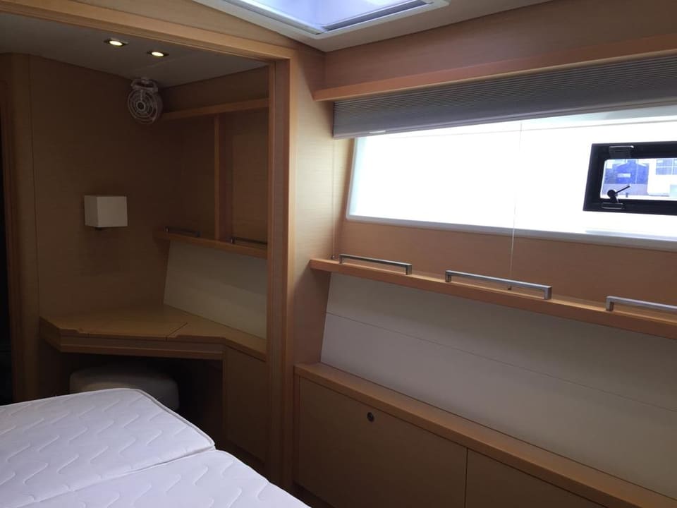 2015 Lagoon 560 S2 – açık meşe ahşap işçilikli misafir kabini, makyaj masası, borda penceresi ve tavan kaportası