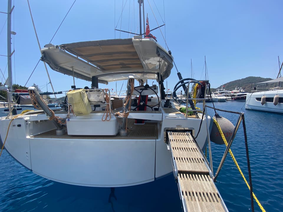 2018 Hanse 548 – stern view with passerelle, open transom, twin helms and bimini-covered cockpit