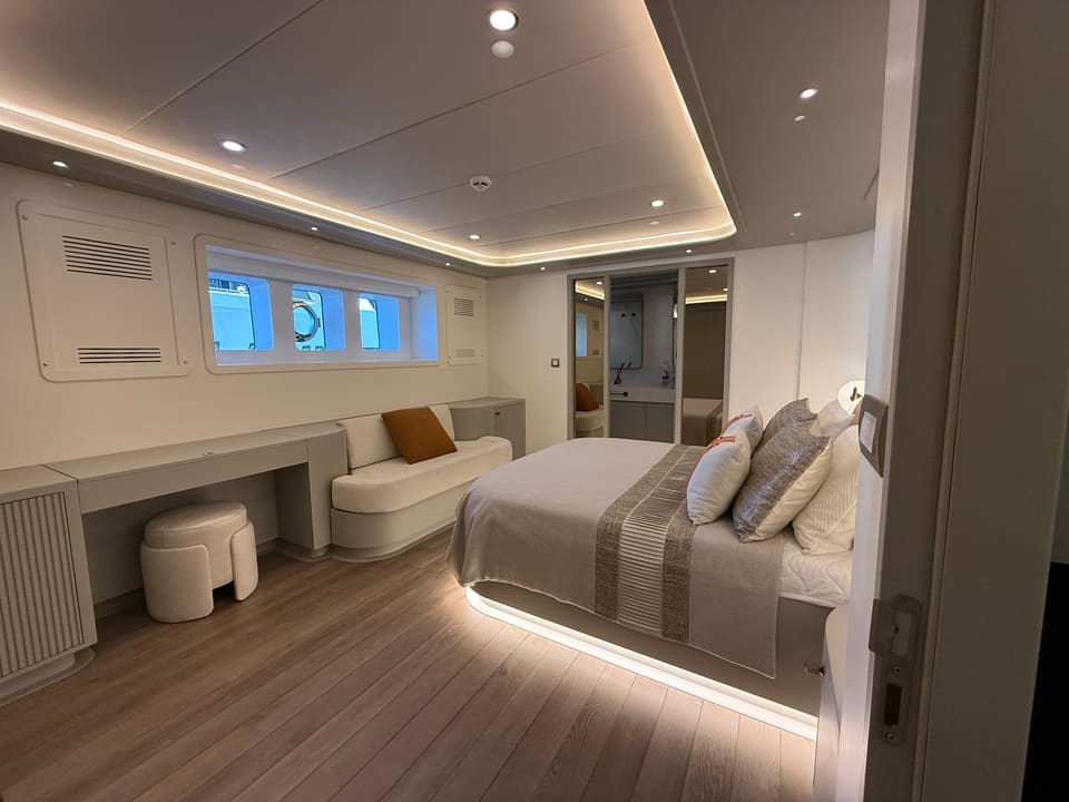 2023 Custom Laminated Motorsailer 41M – cabin with double bed, vanity desk, sofa, portholes and en-suite bathroom