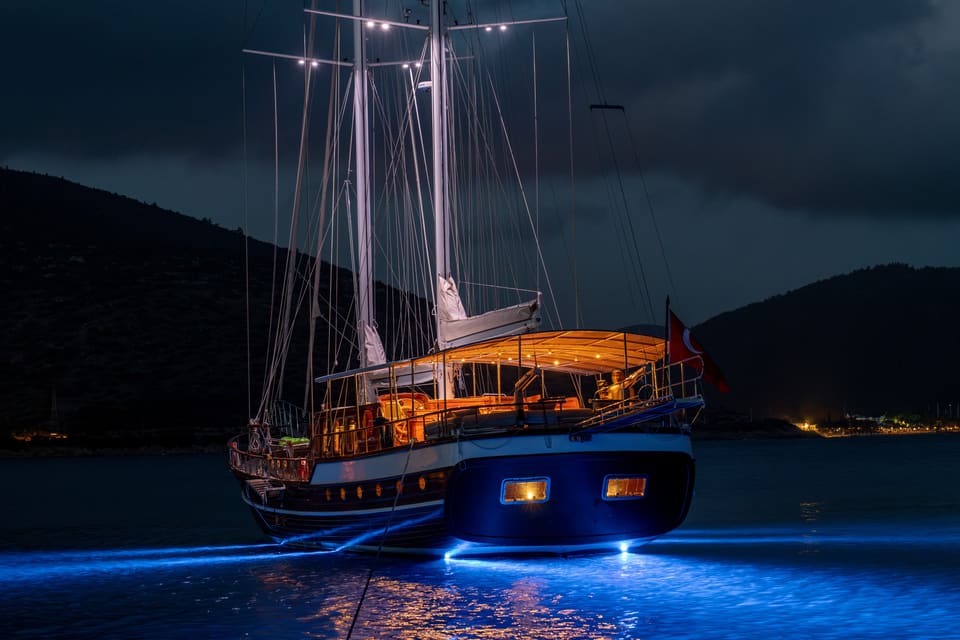 2009 Custom Ketch 31M – stern view at night with illuminated aft deck and blue underwater lights
