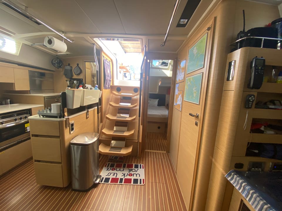 2018 Hanse 548 – galley with oven, sink and counters beside companionway steps leading to a cabin