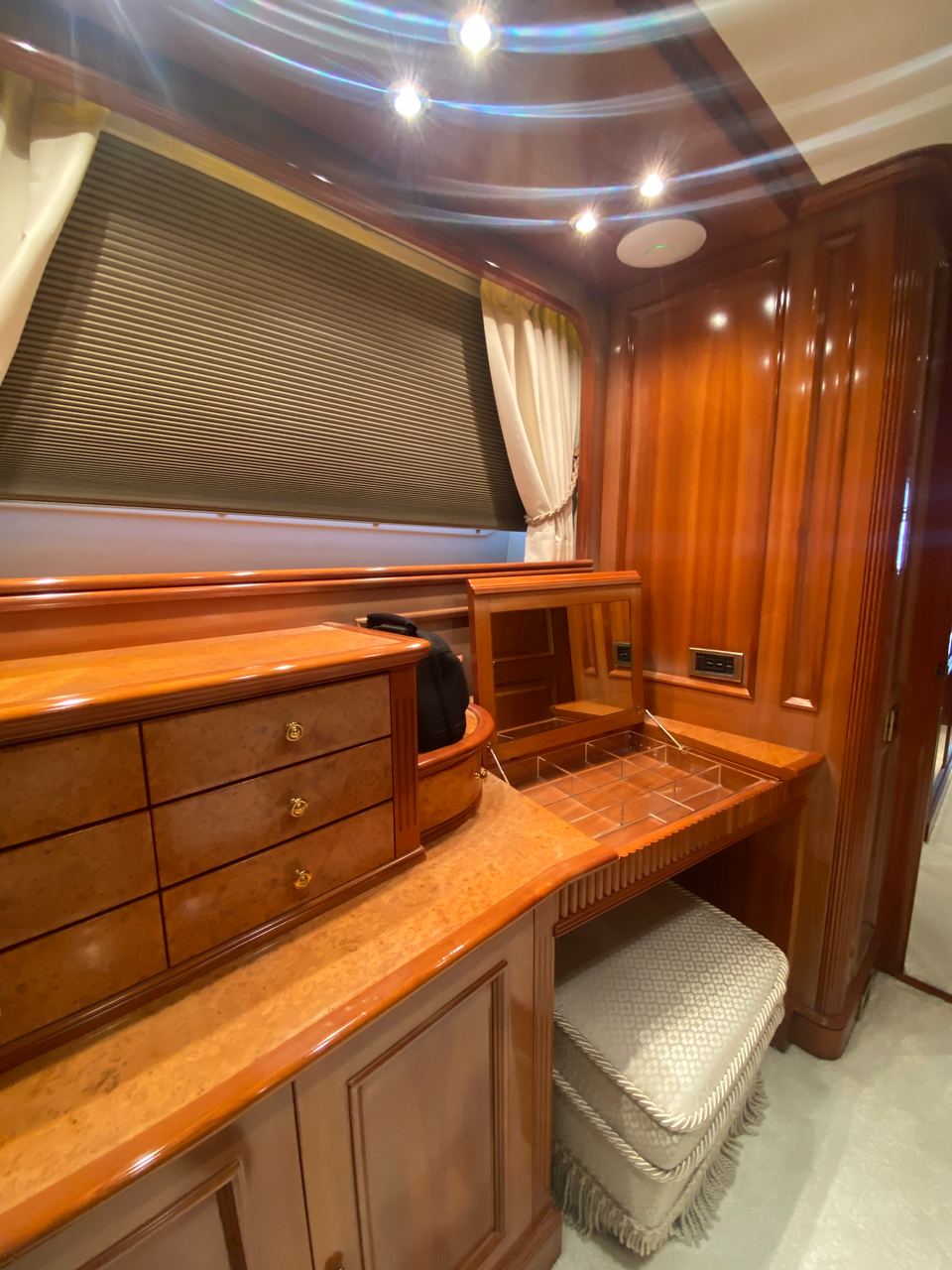 2003 Benetti Classic 115 – cabin vanity with glossy wood drawers, mirror desk and upholstered stool