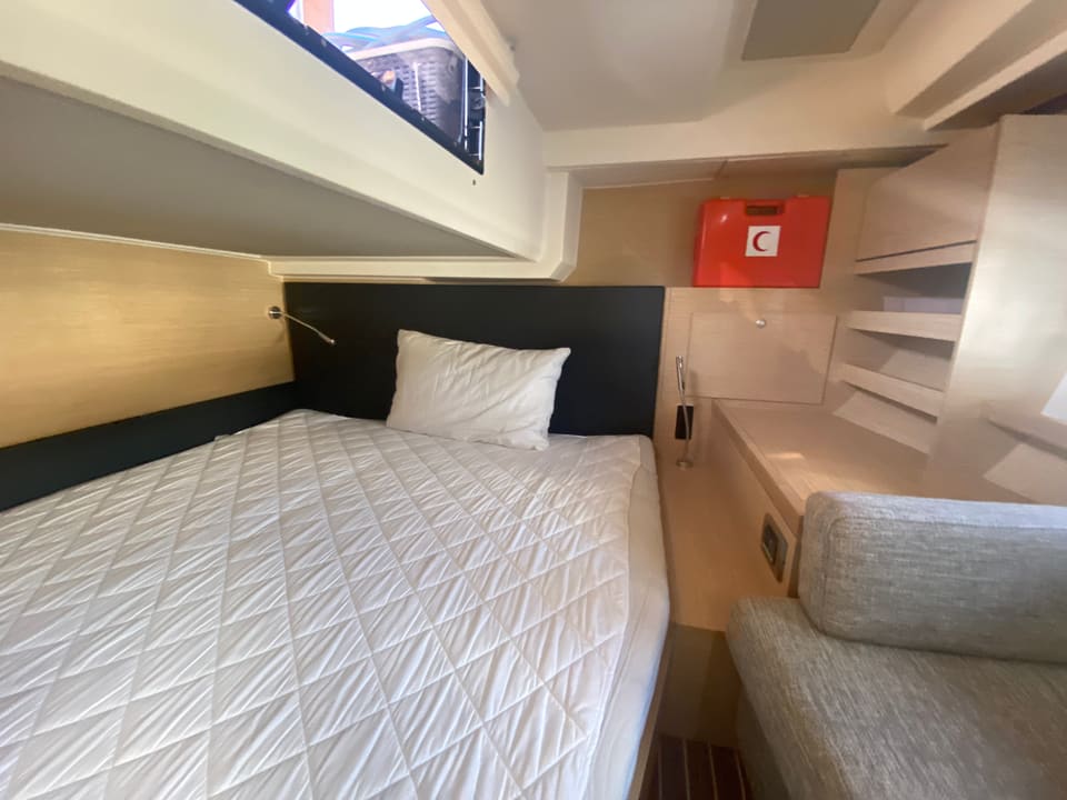 2018 Hanse 548 – guest cabin with double , hull window, reading light, vanity desk and upholstered seat