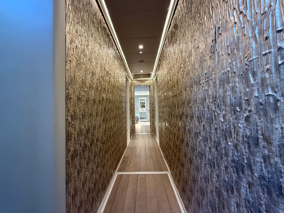 2023 Custom Laminated Motorsailer 41M – narrow corridor with textured metallic wall panels, teak flooring and recessed ceiling lights