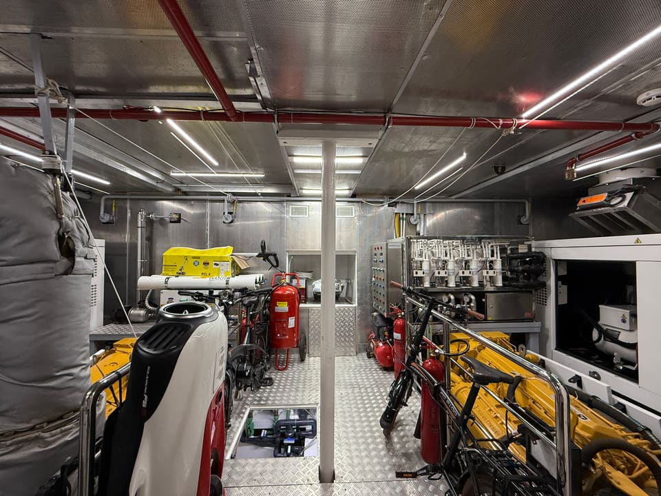 2023 Custom Laminated Motorsailer 41M – engine room with insulated exhaust, fire extinguishers, stowed bicycles and diamond plate floor