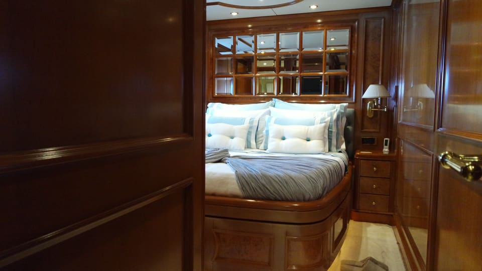 2003 Benetti Classic 115 – guest cabin with double bed, mirrored headboard panel and warm wood joinery