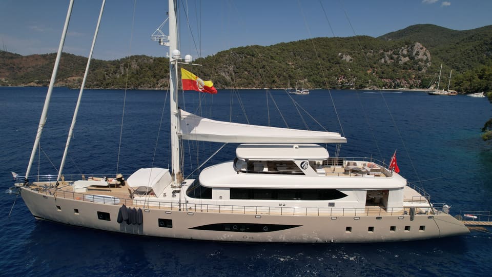 2023 Custom Laminated Motorsailer 41M – profile view of twin-mast sailing yacht with cream hull and white superstructure at anchor