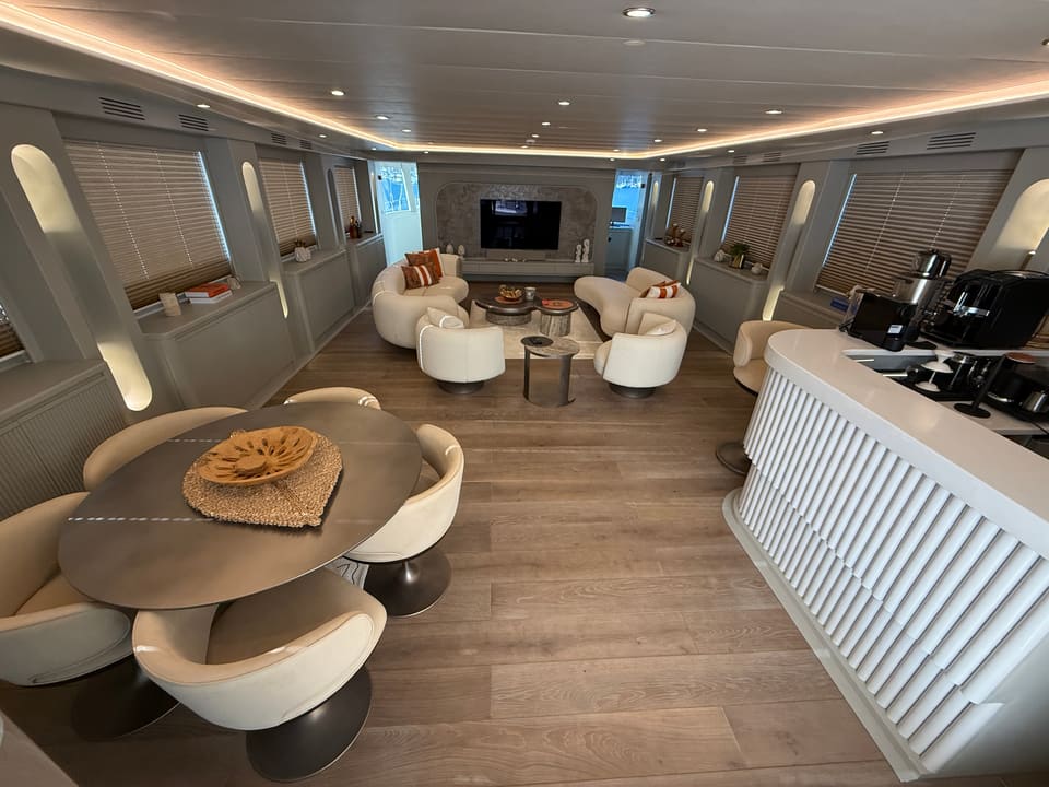 2023 Custom Laminated Motorsailer 41M – main saloon with lounge seating, TV, round dining table and bar counter