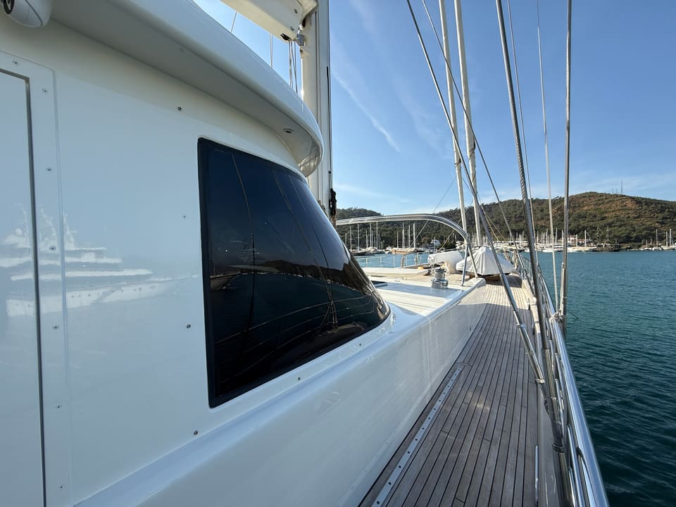 2023 Custom Laminated Motorsailer 41M – teak side deck with tinted superstructure window, stainless railings and masts