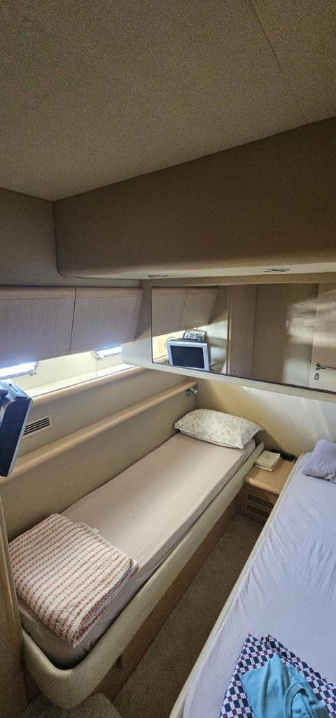 2005 Ferretti 530 – twin guest cabin with single , hull windows, mirror and overhead storage lockers