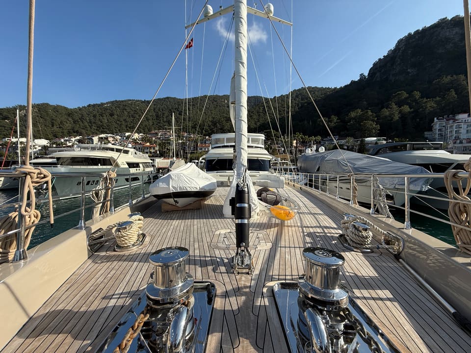2023 Custom Laminated Motorsailer 41M – teak foredeck with chrome capstans, mast, coiled lines and covered tender