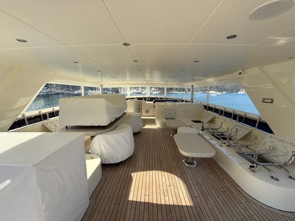 2023 Custom Laminated Motorsailer 41M – covered flybridge with teak deck, protected seating, tables and helm console
