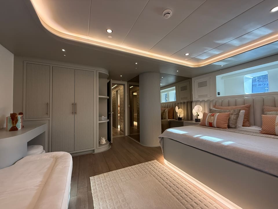 2023 Custom Laminated Motorsailer 41M – master cabin with double bed, peach cushions, vanity desk, wardrobes and ambient ceiling lighting