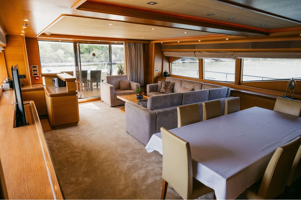 2007 Custom Line 97 – L koltuklu ana salon, sekiz kişilik yemek masası ve kıç güverteye açılan sürgülü kapılar