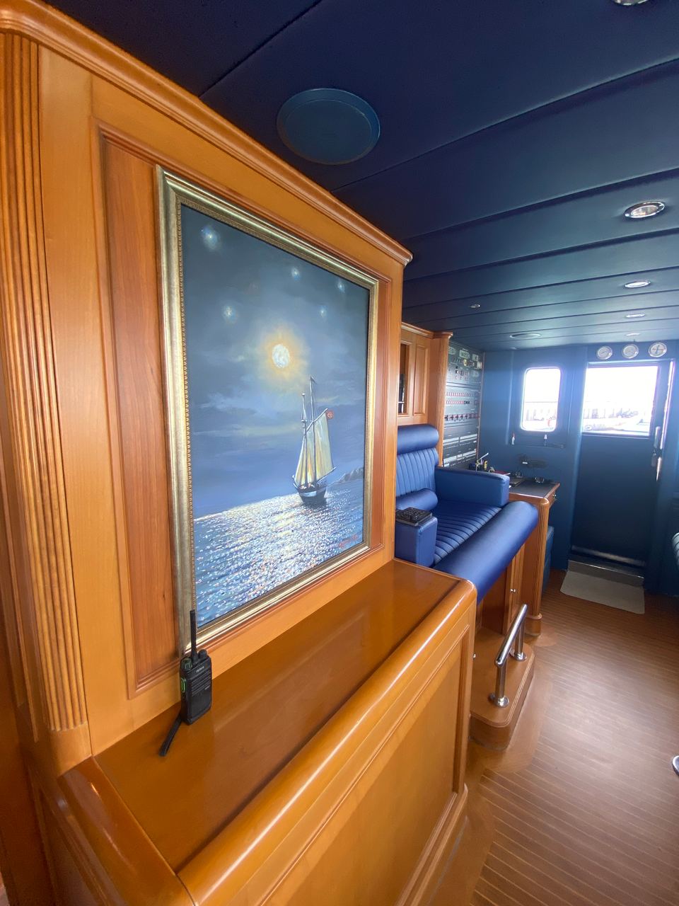 2003 Benetti Classic 115 – wheelhouse with blue helm chair, cherry wood joinery and moonlit sailboat painting